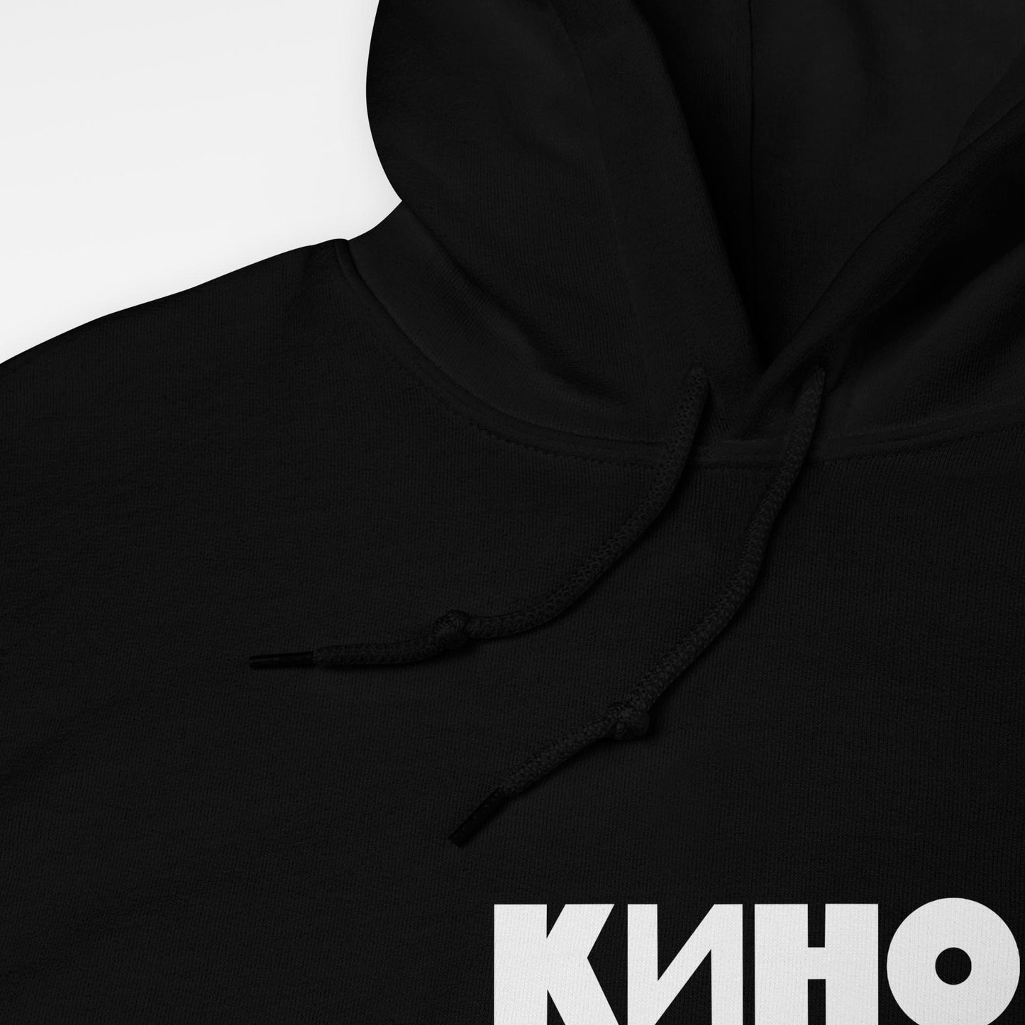 Black hoodie with white КИНО band logo printed on front and back. Official Soviet rock band merch. Front closeup photo. Viktor Tsoi sweatshirt from www.kinoband.com