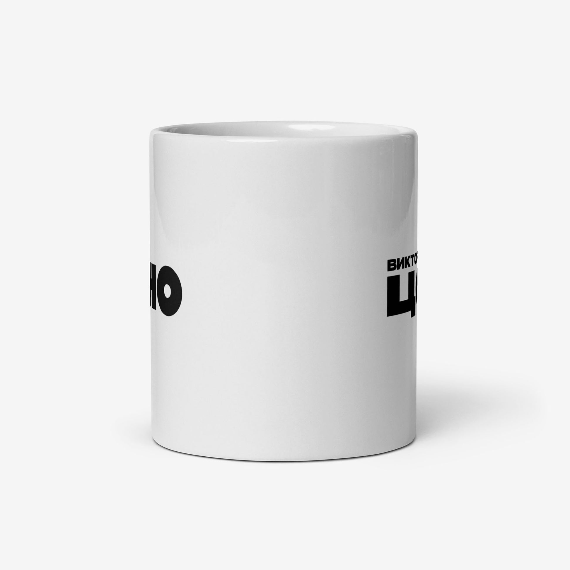 White coffee mug with bold white КИНО (KINO) band logo. Official Viktor Tsoi Soviet rock merch. Side photo. From www.kinoband.com