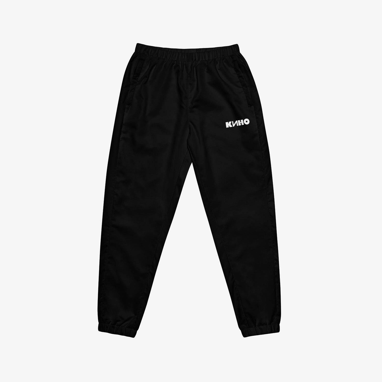 Black official KINO band sport pants like Viktor Tsoi had. With KINO logo on the left pant. Premium cuffed joggers. Front side. From www.kinoband.com