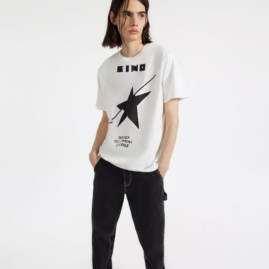 A young handsome boy model wearing premium unisex white T-shirt with official 'A star called Sun' (Zvezda) album cover by Viktor Tsoi and Gruppa Kino band. From kinoband.com