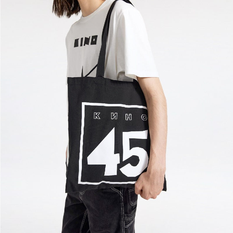 A young handsome boy model wearing official premium unisex white T-shirt with official 'A star called Sun' (Zvezda) album cover by Viktor Tsoi and Gruppa Kino band. Closeup photo. From www.kinoband.com