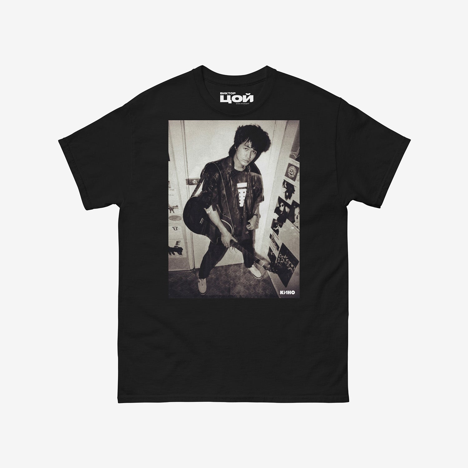 Official KINO band tshirt (black unisex Tee) with large rare photo of Viktor Tsoi in wearing a bomber jacket with guitar in an apartment. From kinoband.com